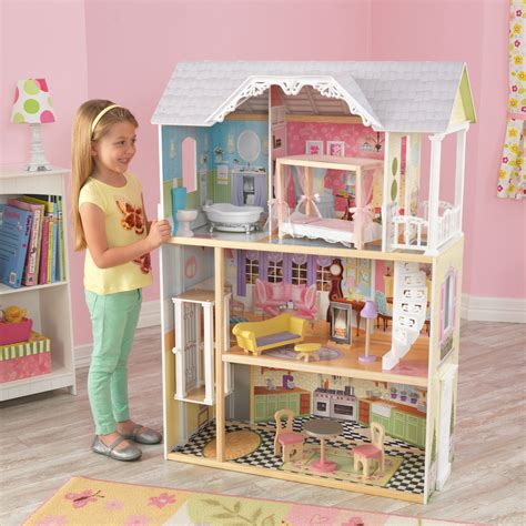 An intricate winding staircase leads to the top-level expansive bedroom with elegant canopy bed. . Kidkraft dollhouses